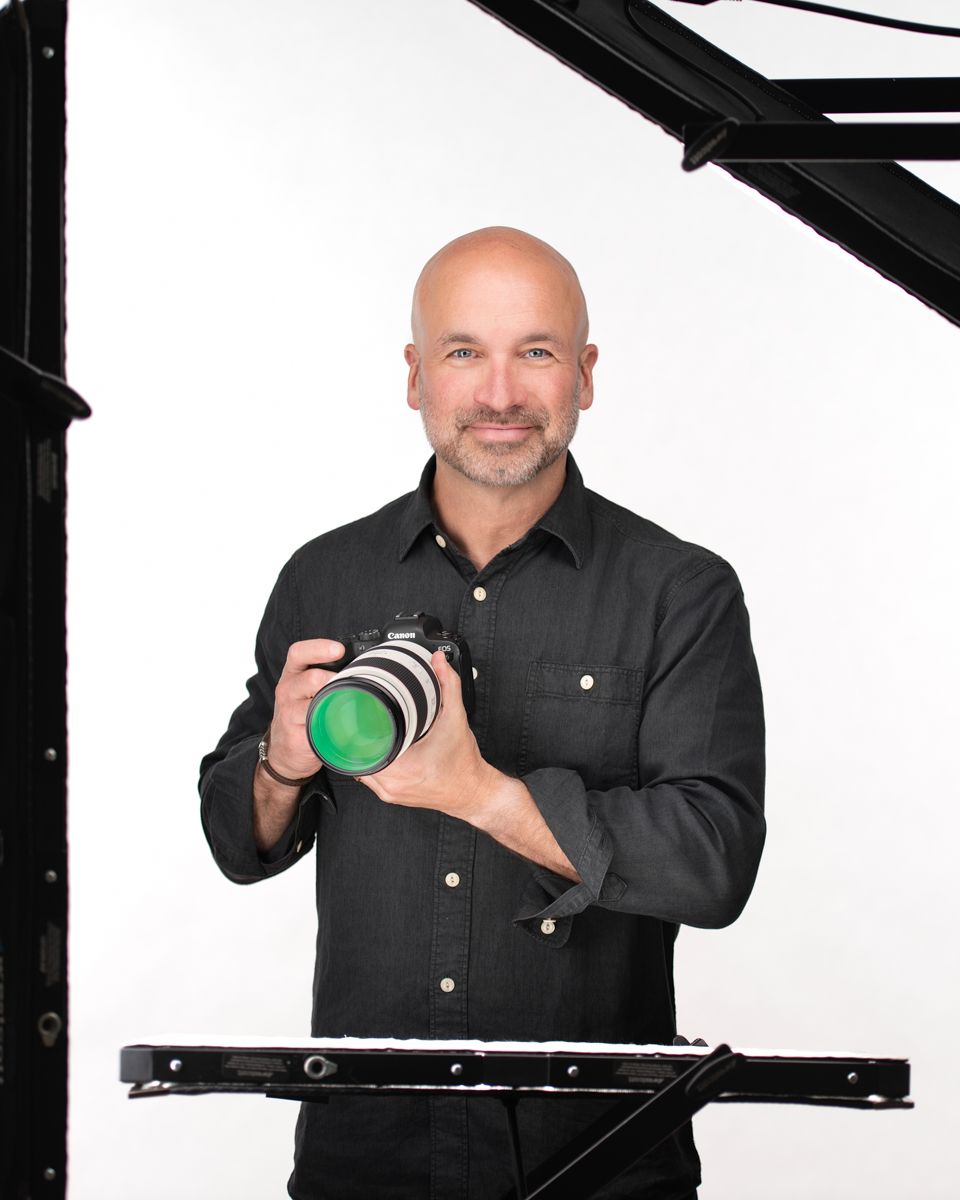 Adam, founder and photographer of Boop Photo, holding a camera